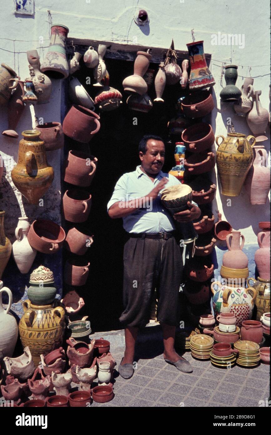 A man sells clay pots in a shop in Nabeul. [automated translation