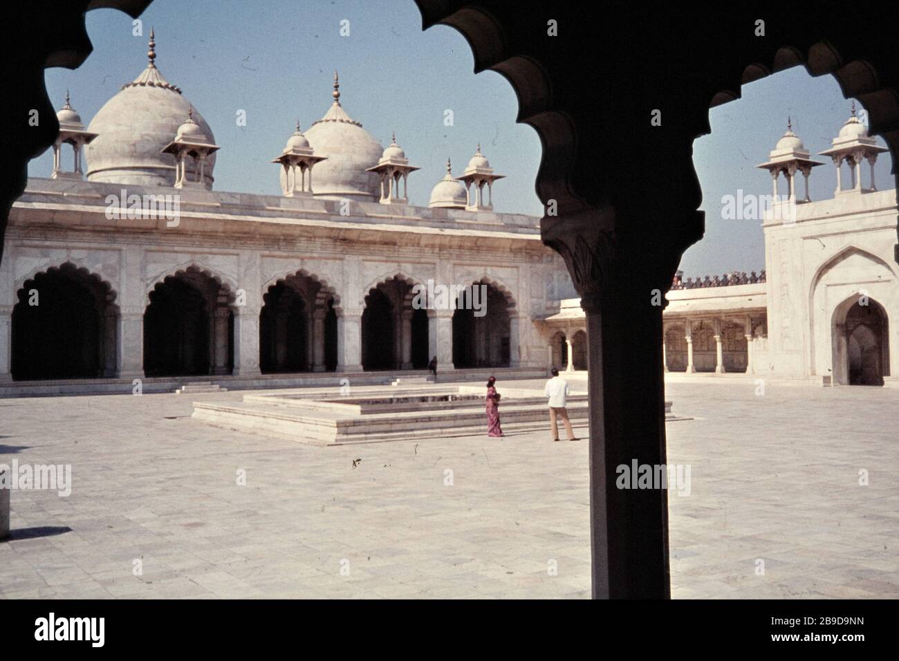 A man and a woman are standing in the courtyard of the Moti Masjid ...