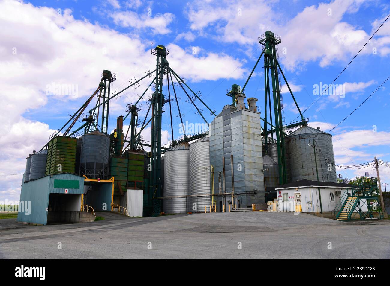 Driving around the backroads of Quebec you find these enormous farms where they grow soy beans and keep the produce in large steel tanks on the farm Stock Photo