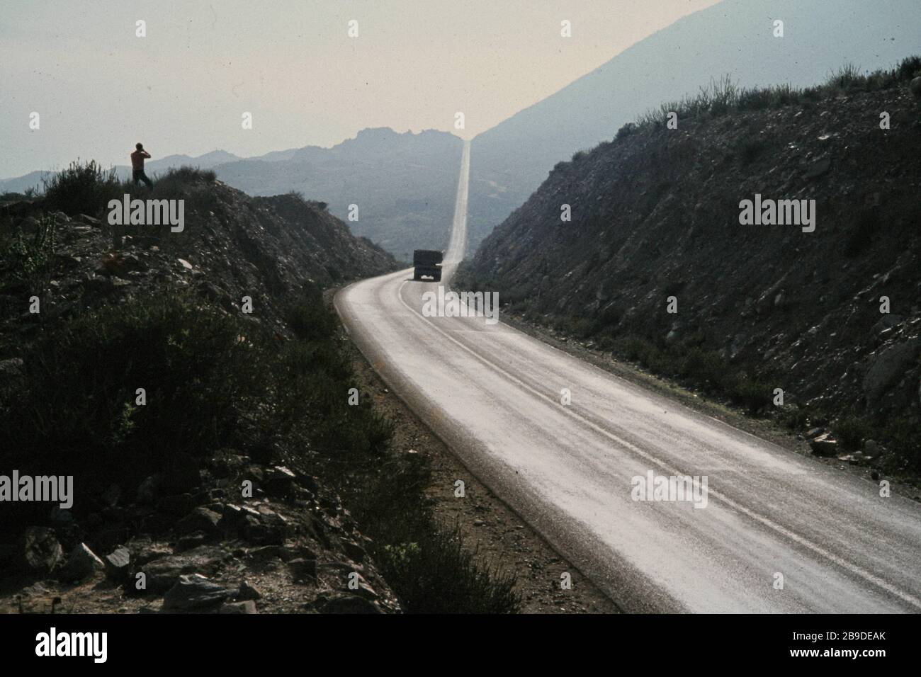 A tourist photographs a straight stretch of the Panamericana, the