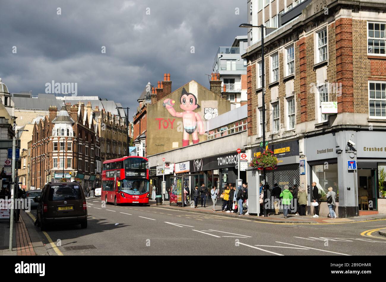 Croydon, UK - October 2, 2019: View looking north along Croydon High Street on a sunny autumn day with looming storm clouds. Stock Photo