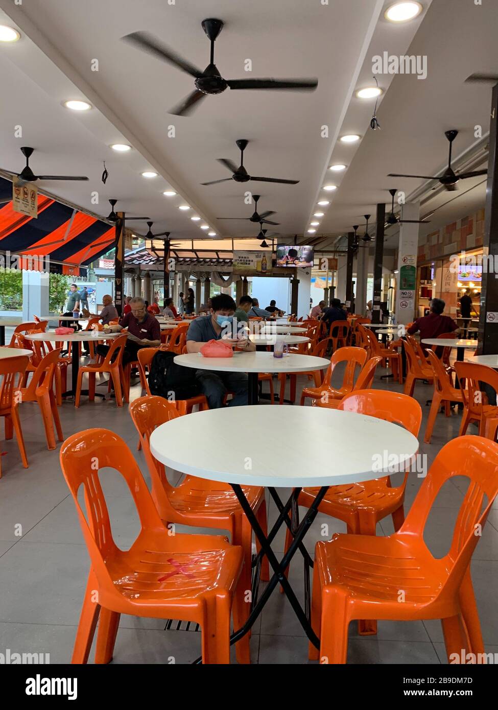 Food court chairs at the 409 Ang Mo Kio Market and hawker centre in  Singapore are marked with red stripes to indicate that people should not  sit on them on March 24,