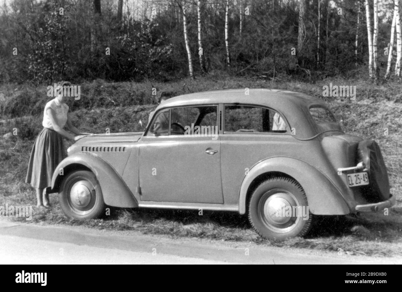 A woman stands in front of an Opel Kapitän in the GDR, 1956. [automated translation] Stock Photo