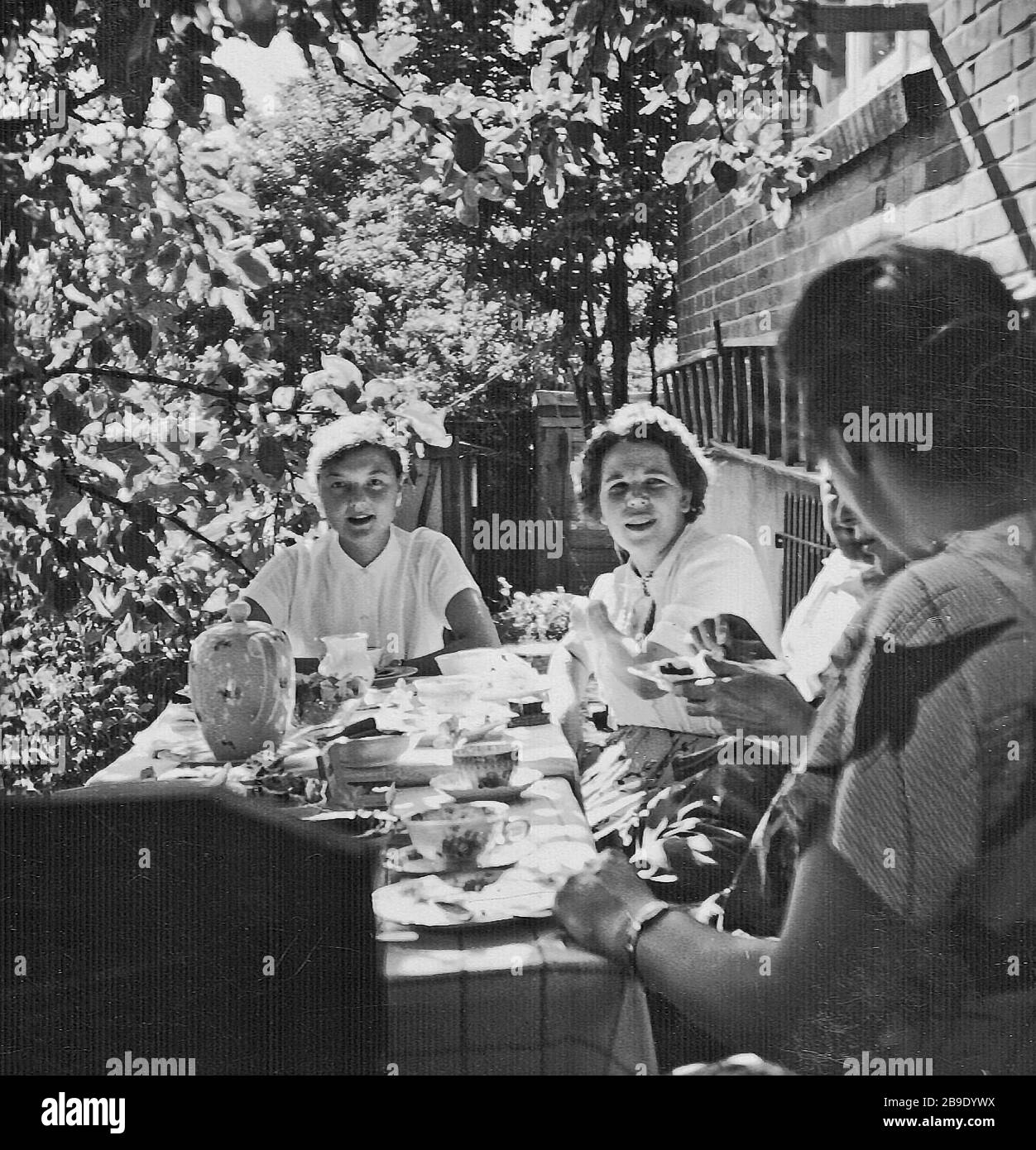 A group of five women having a coffee party in a garden. [automated ...