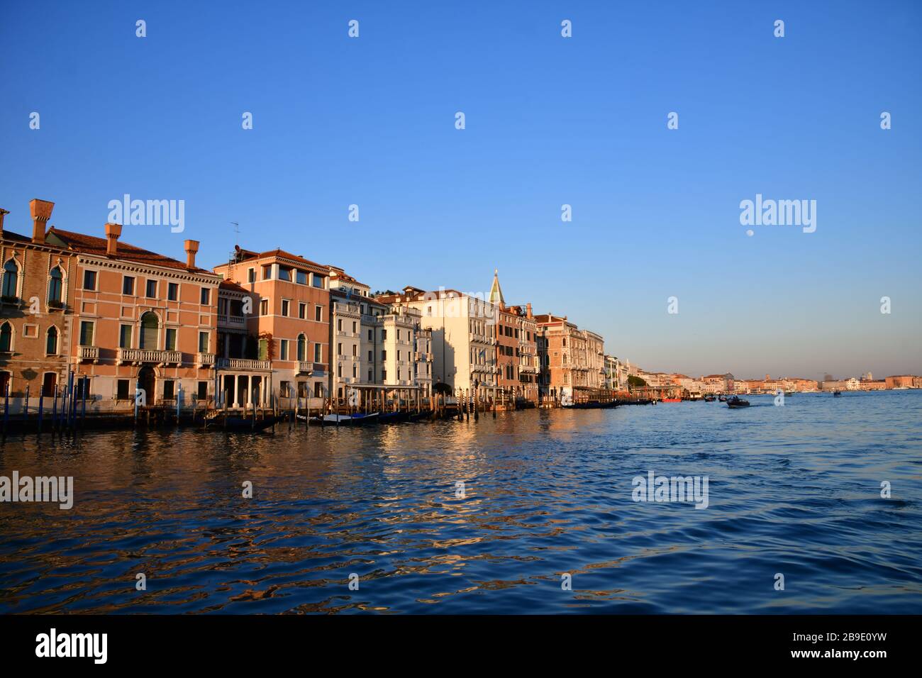 Row of colourful houses on the quay along the laguna of Venice Stock Photo