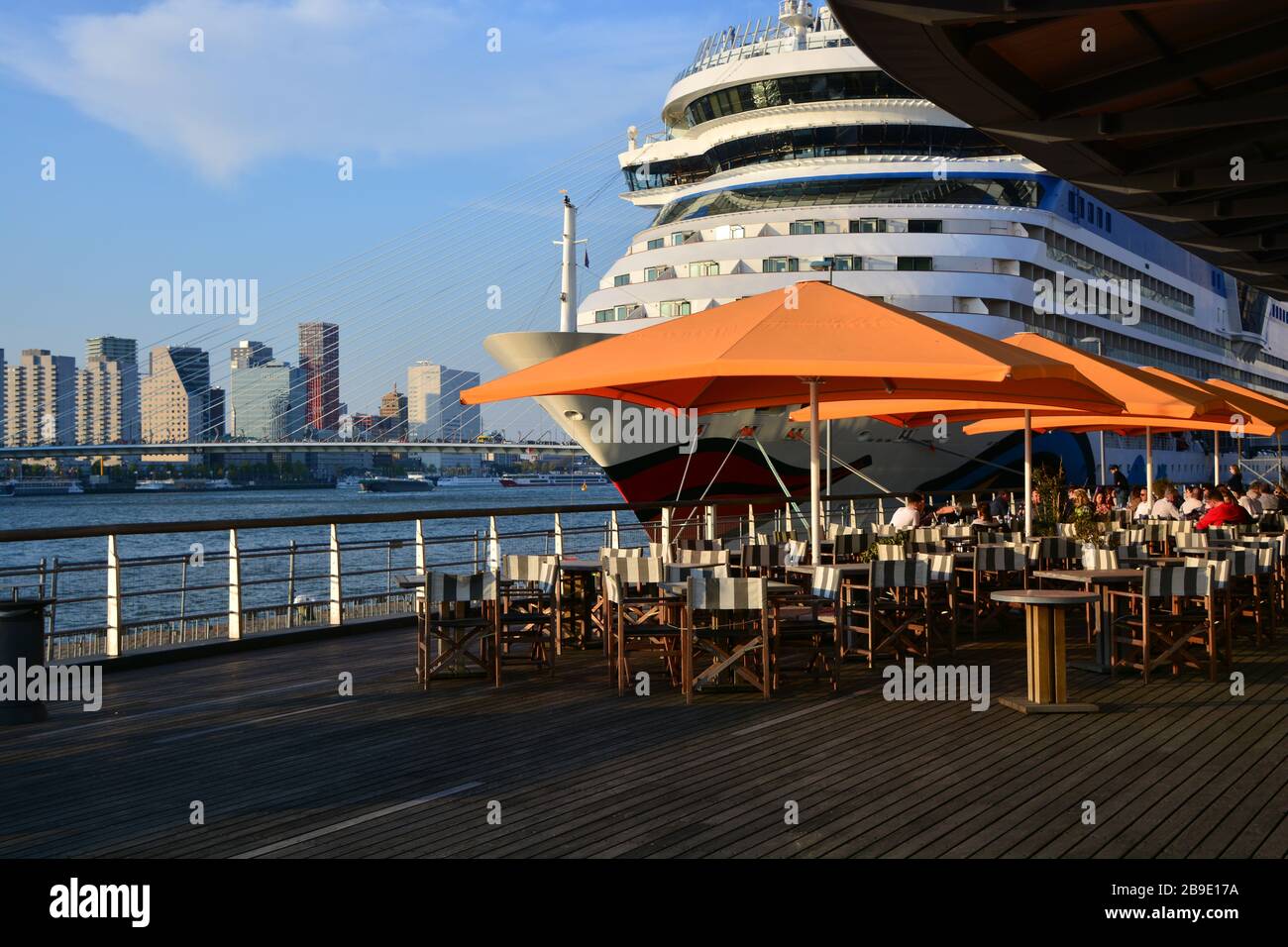 Close up of bow Cruise ship docked at Wilhelminapier Rotterdam with terrace in forefront and cityscape in the background Stock Photo