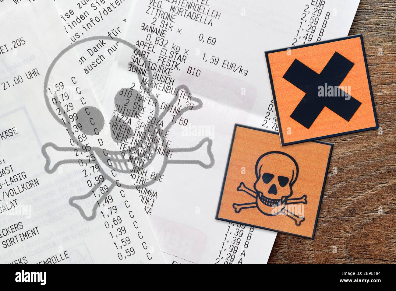 PHOTOMONTAGE, receipts with danger sign, symbolic photo for poison materials in thermo paper, FOTOMONTAGE, Kassenbons mit Gefahrenzeichen, Symbolfoto Stock Photo