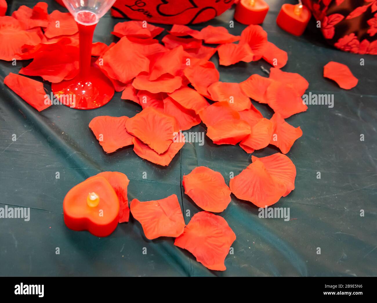 Close up imitation or artificial red roses leaves background Stock