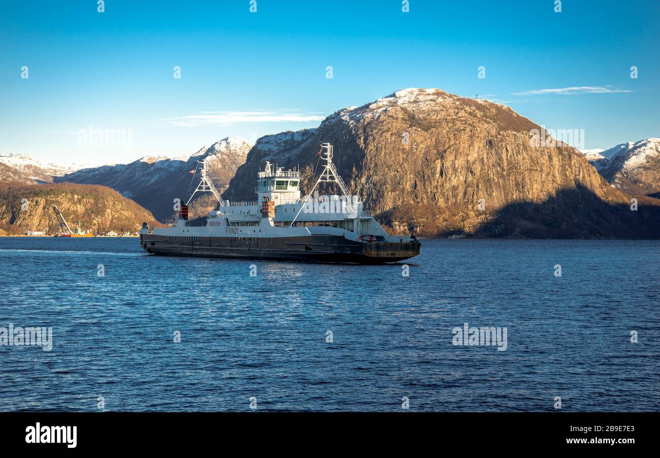 A regular passenger ferry is crossing Frafjord on Lauvvik-Oanes route popular among tourists visiting Preikestolen or Pulpit Rock, Norway, February 20 Stock Photo