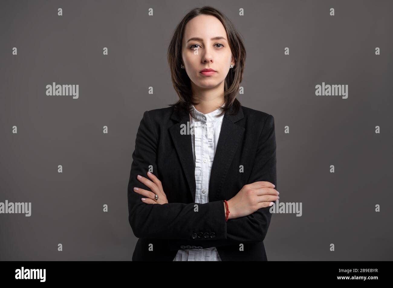 Portrait of wonderful young business woman wering black suit and shirt ...