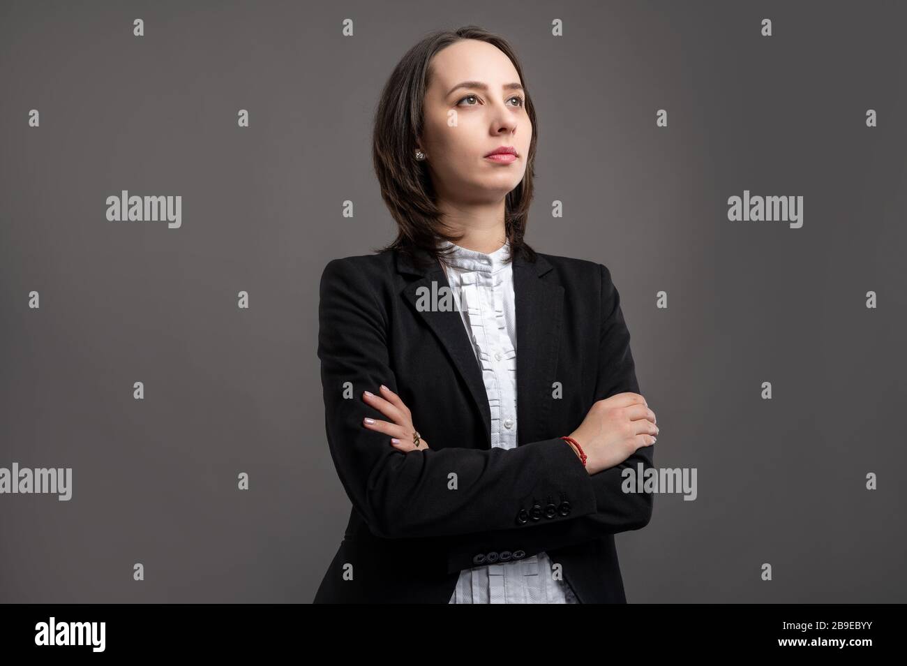 Portrait of wonderful young business woman wering black suit and shirt ...
