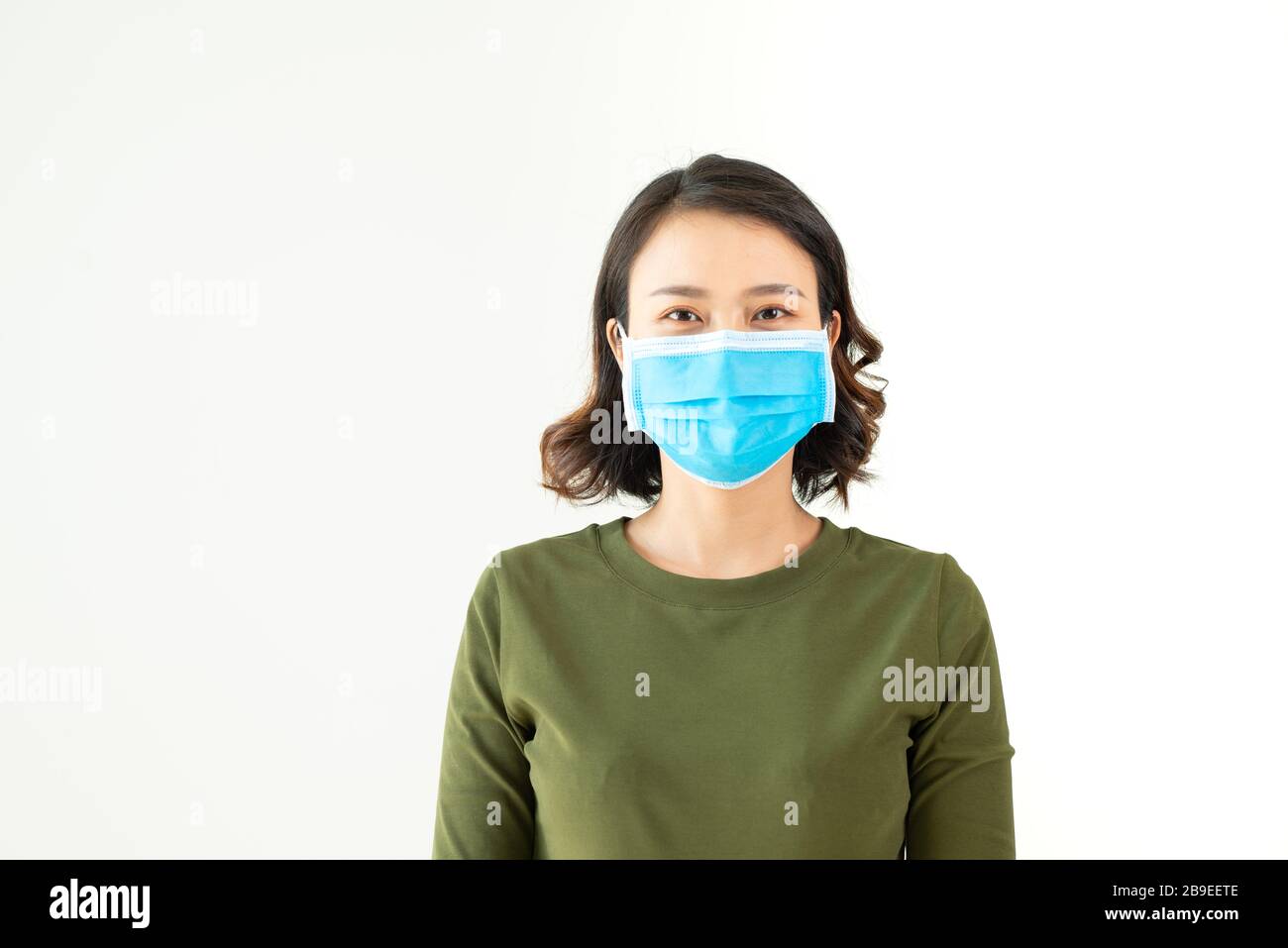 Asian woman wearing facial mask for protection from air pollution or virus epidemic on white background Stock Photo