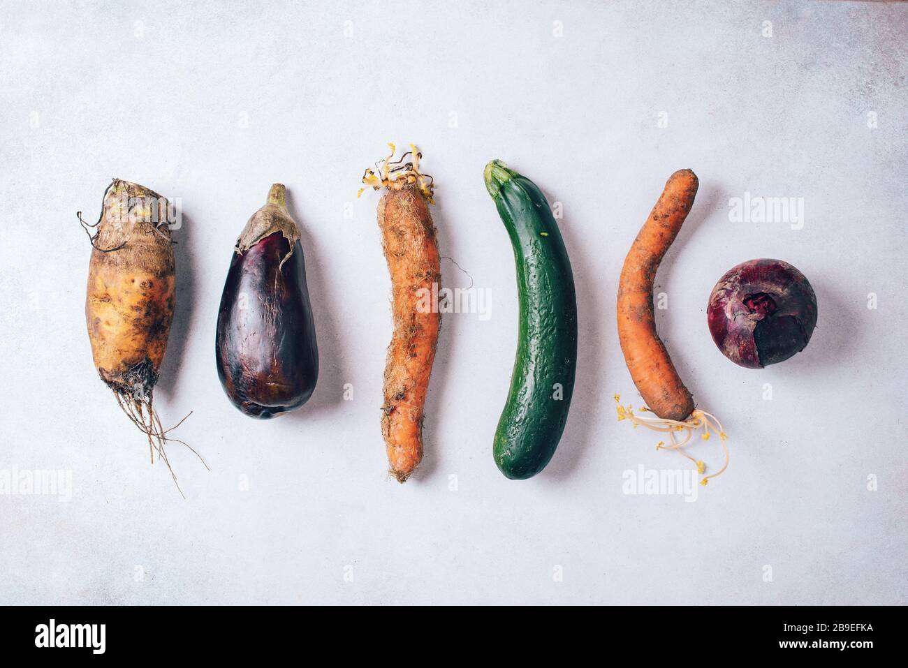 Ugly organic farm vegetables with mutations on craft paper background ...