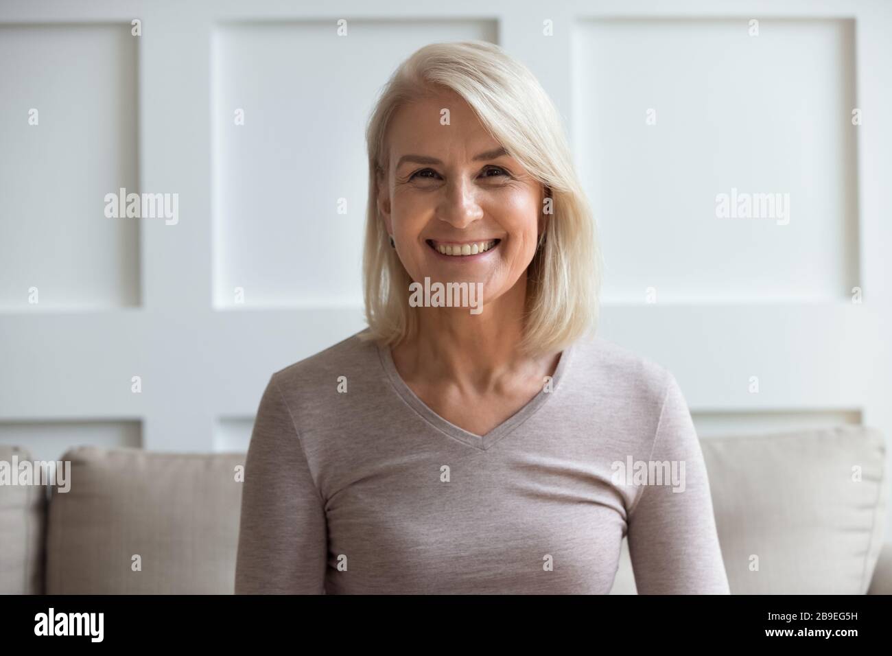 Head shot portrait smiling older woman looking at camera Stock Photo ...