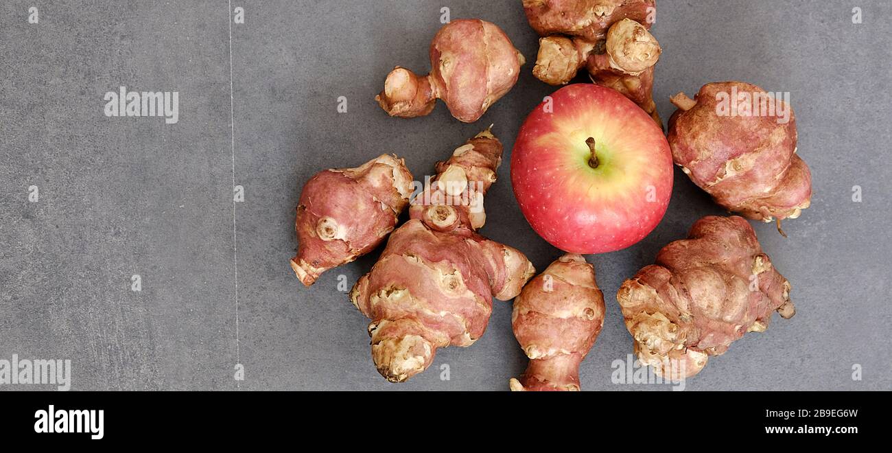 Jerusalem artichoke and red apple Stock Photo Alamy