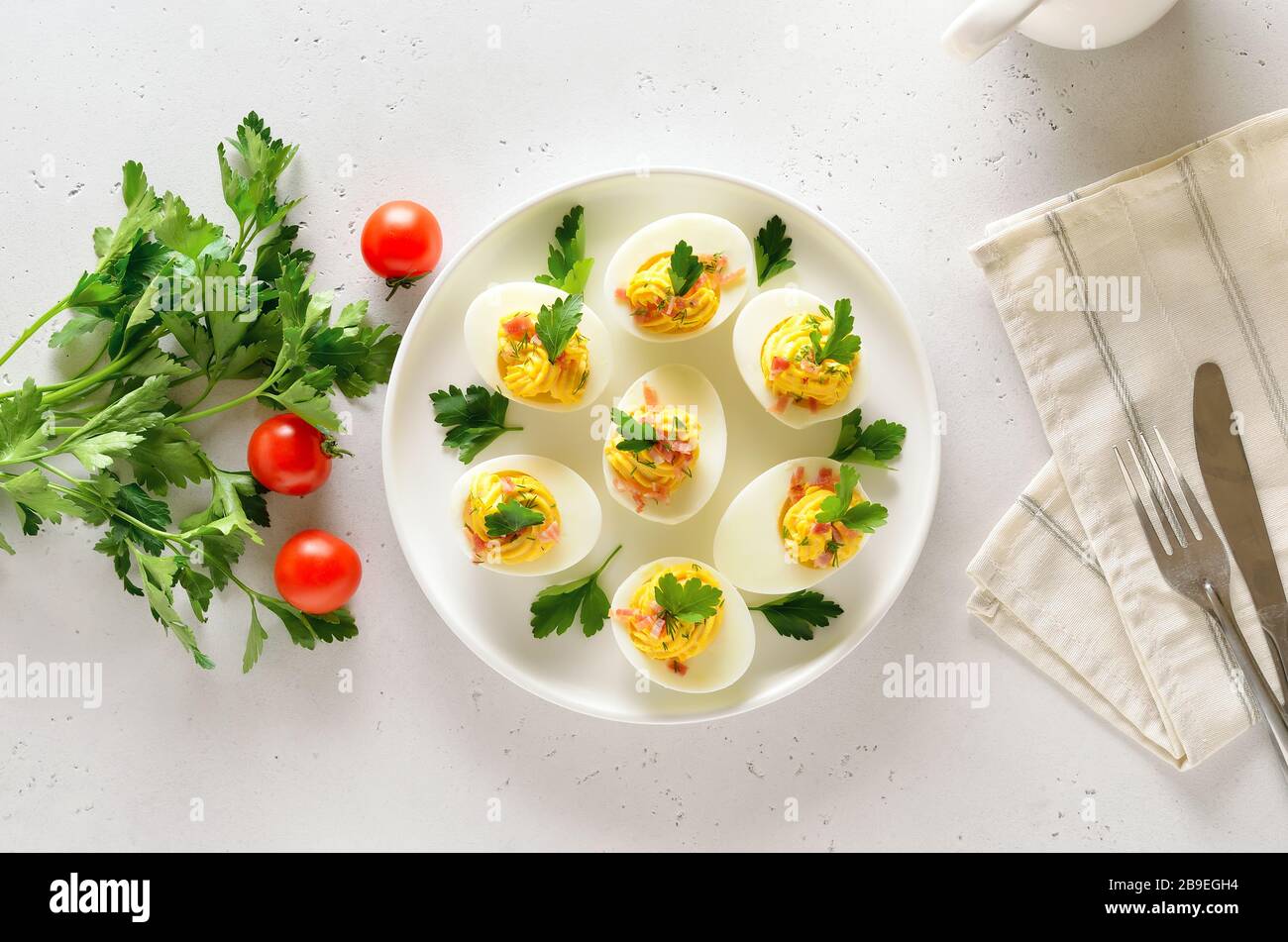 Stuffed eggs with egg yolk, bacon, mustard and parsley. Healthy diet food for breakfast. Top