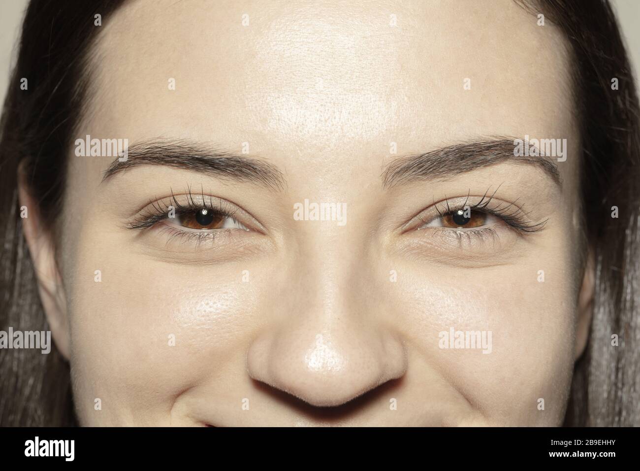 Smiling. Close up of face of beautiful caucasian young woman, focus on ...