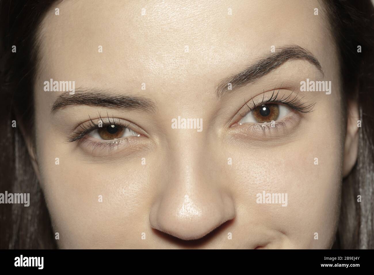 Asking. Close up of face of beautiful caucasian young woman, focus on ...