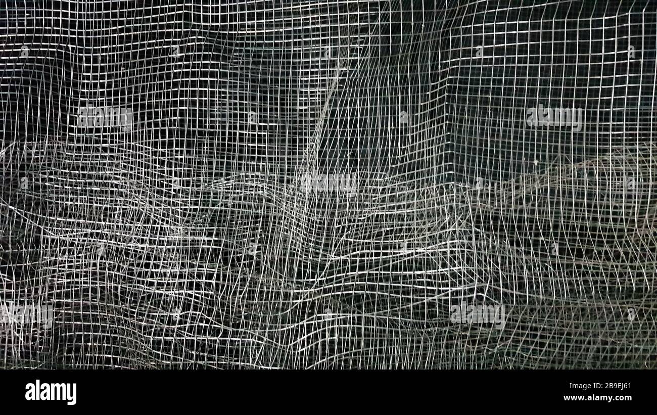Crumpled mesh. Abstract background. Metal mesh with shadow on a