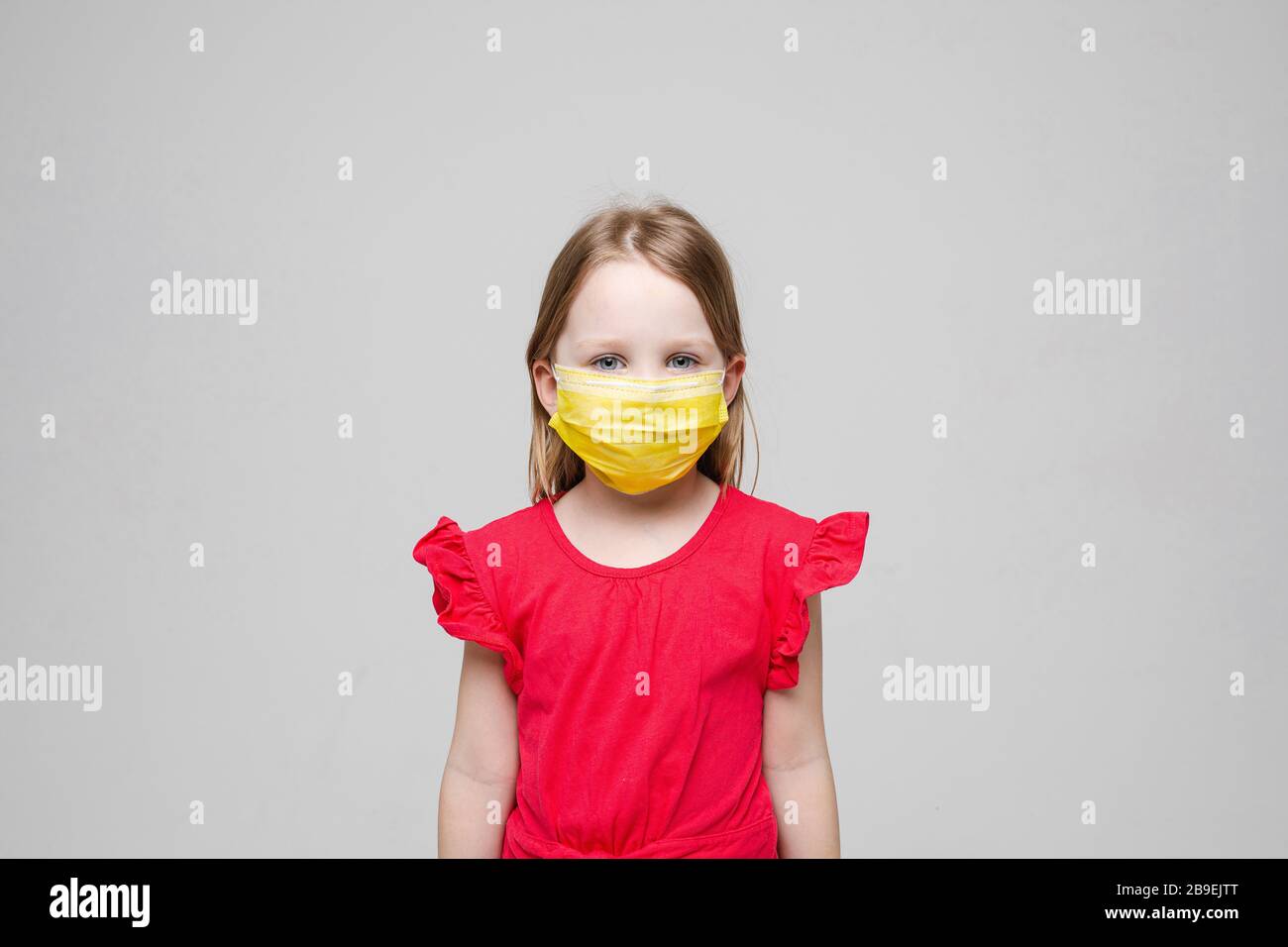 portrait-of-little-girl-with-yellow-medical-mask-on-her-face-isolated