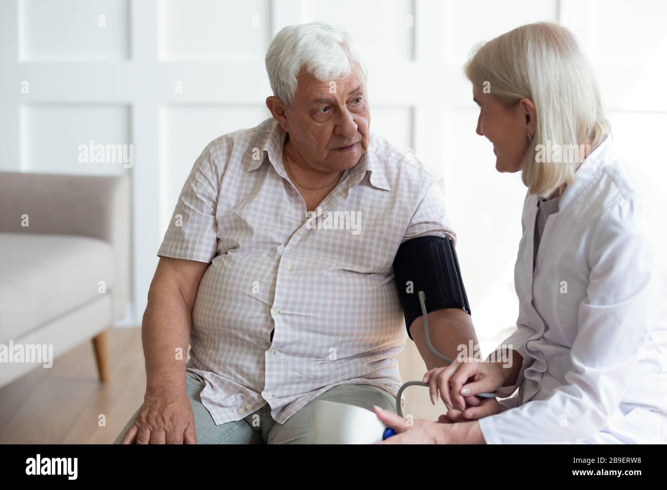 Doctor pulse mature patient during hi-res stock photography and images ...