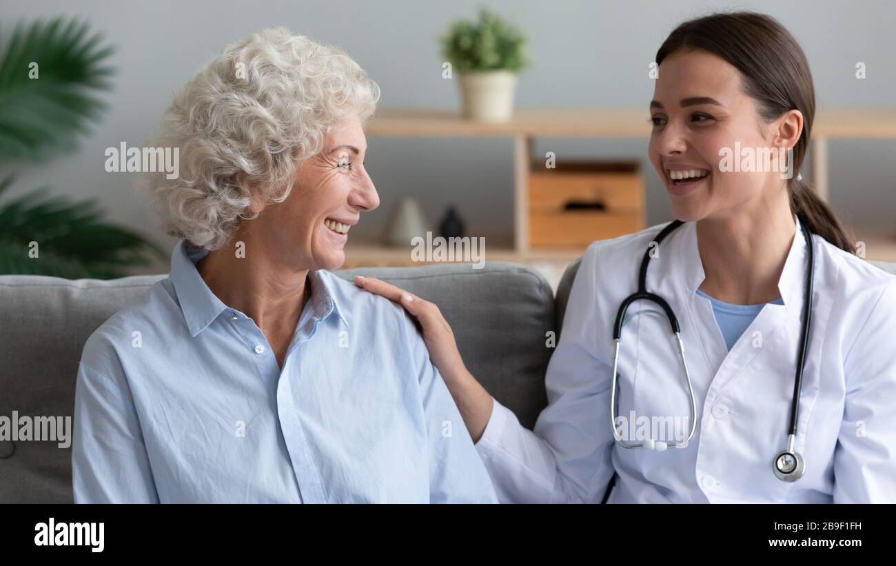 Positive female caregiver support senior woman patient Stock Photo