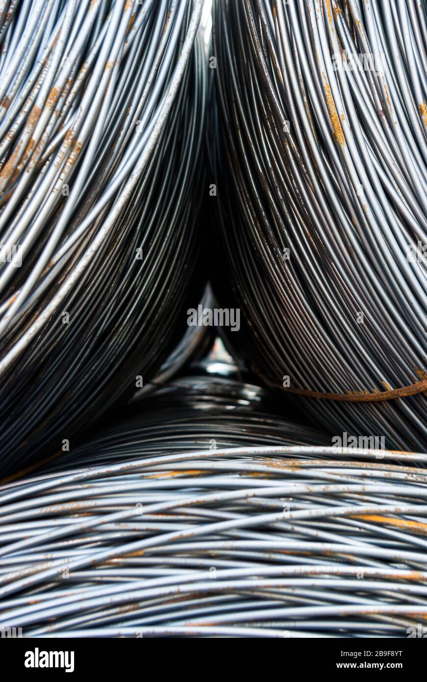 Round steel in rings in the material bearing several rings stacked, selective focus, Rundstahl in Ringen im Materiallager mehrere Ringe gestapelt, sel Stock Photo