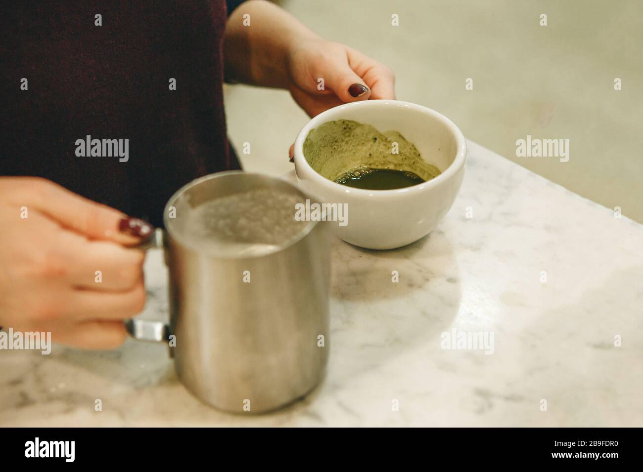 Barista prepares tasty and healthy matcha latte tea. Stock Photo