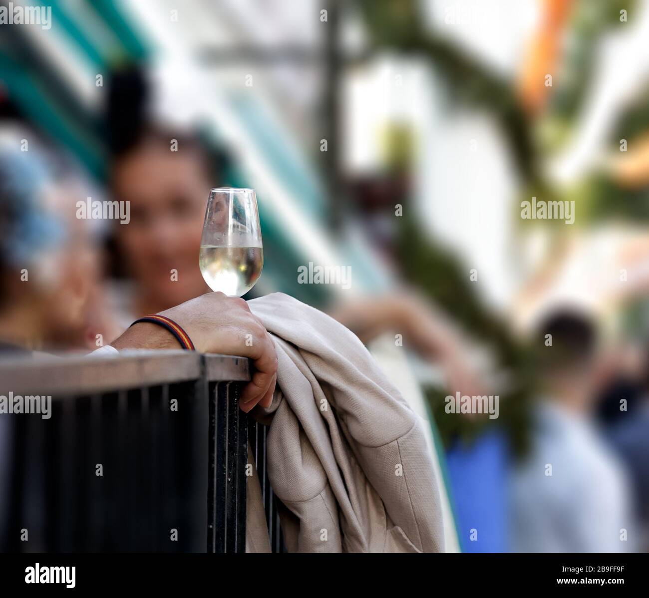 Hand holding glass of fino sherry (manzanilla sherry) at the April Fair