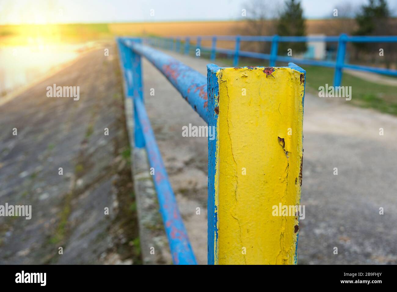 Old blue and yellow rusty handrail outside Stock Photo - Alamy