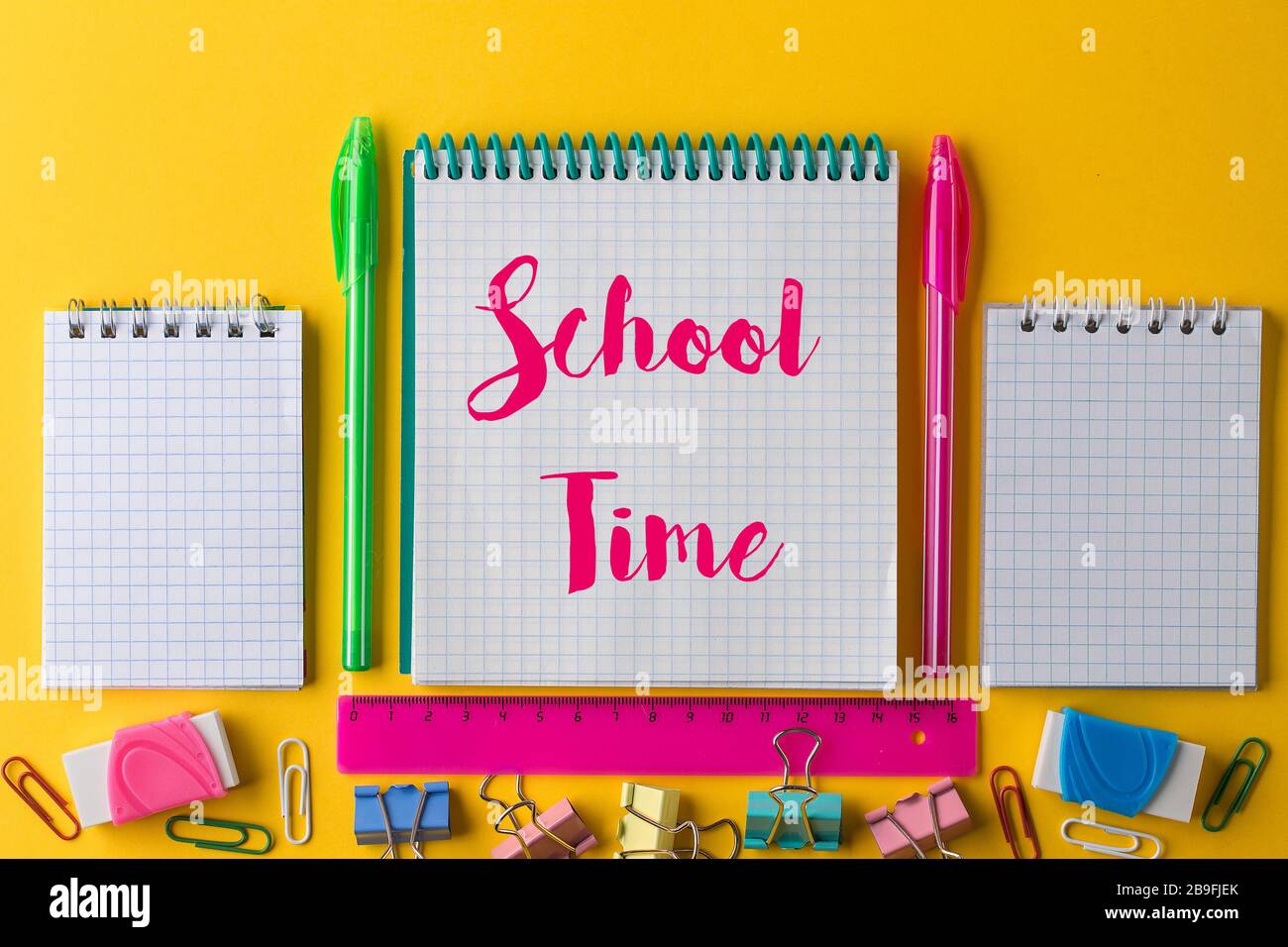 Creative flat lay back to school concept with Notepad on bright yellow ...