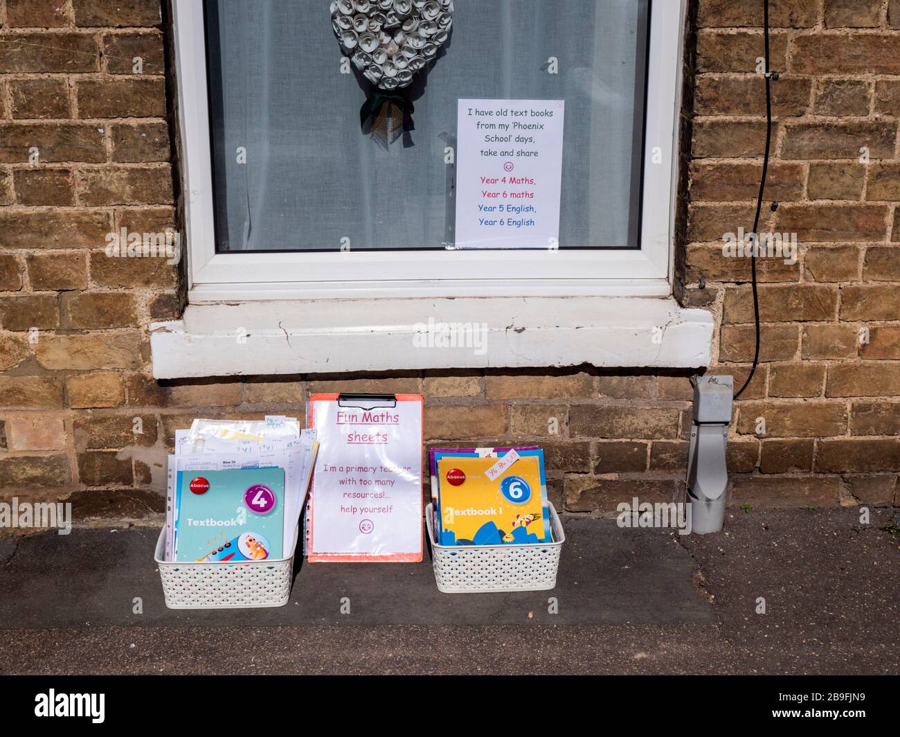 Willingham Cambridgeshire, UK. 24th Mar, 2020. A community minded teacher offers free books and resources outside their house to help people with home schooling while children are off school because of the Coronavirus shut down. This is the morning after the night people across the UK were told to stay at home to restrict the spread of the Covid 19 virus. Credit: Julian Eales/Alamy Live News Stock Photo