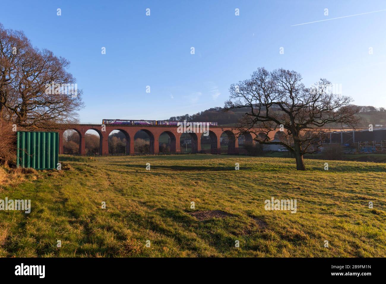 Northern rail class 142 pacer train 142078 + class 150 sprinter 150201 crossing brick built Whalley viaduct, Lancashire on the Ribble valley line Stock Photo