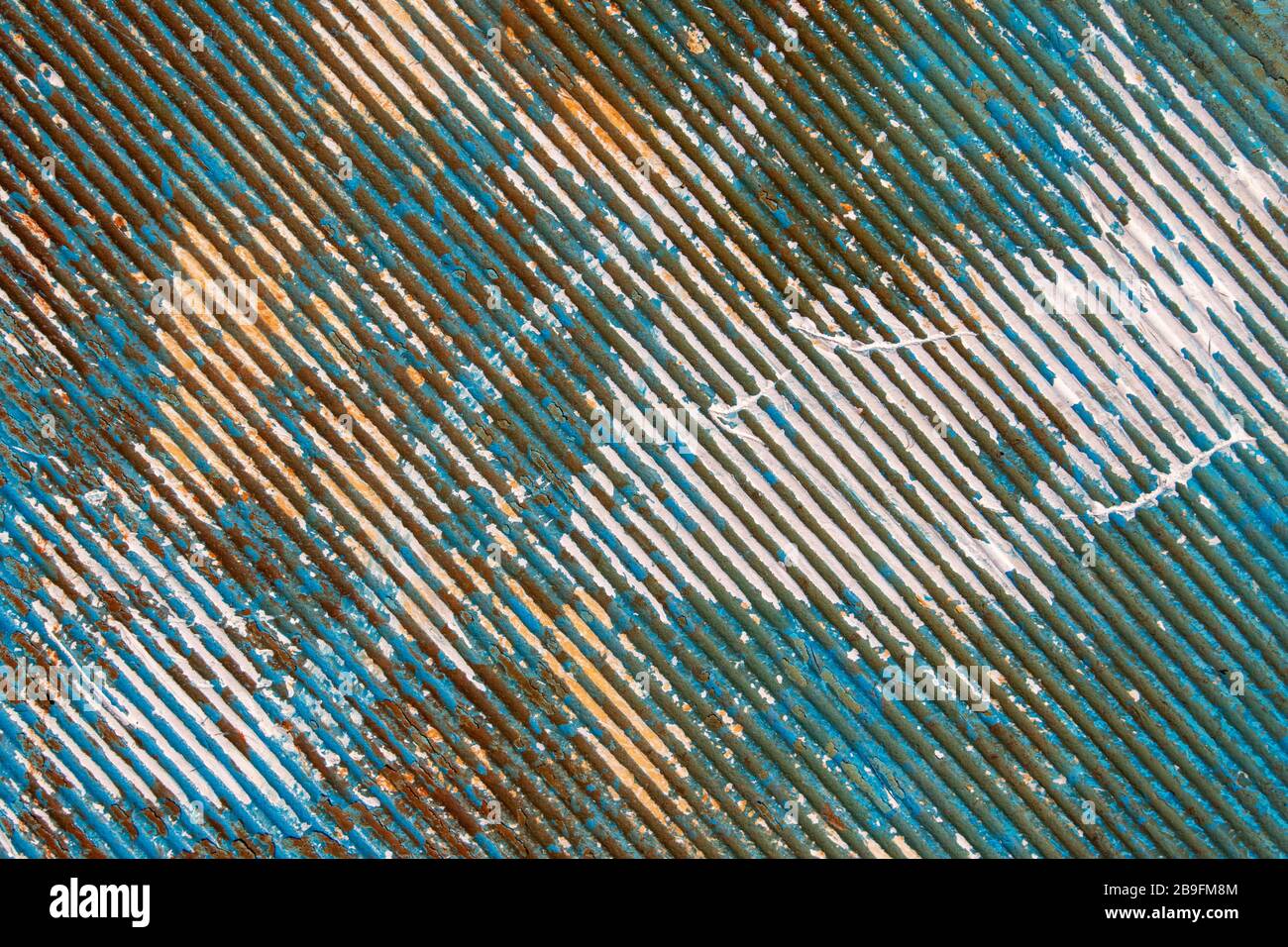 Peeling paint on rusty corrugated metal Stock Photo