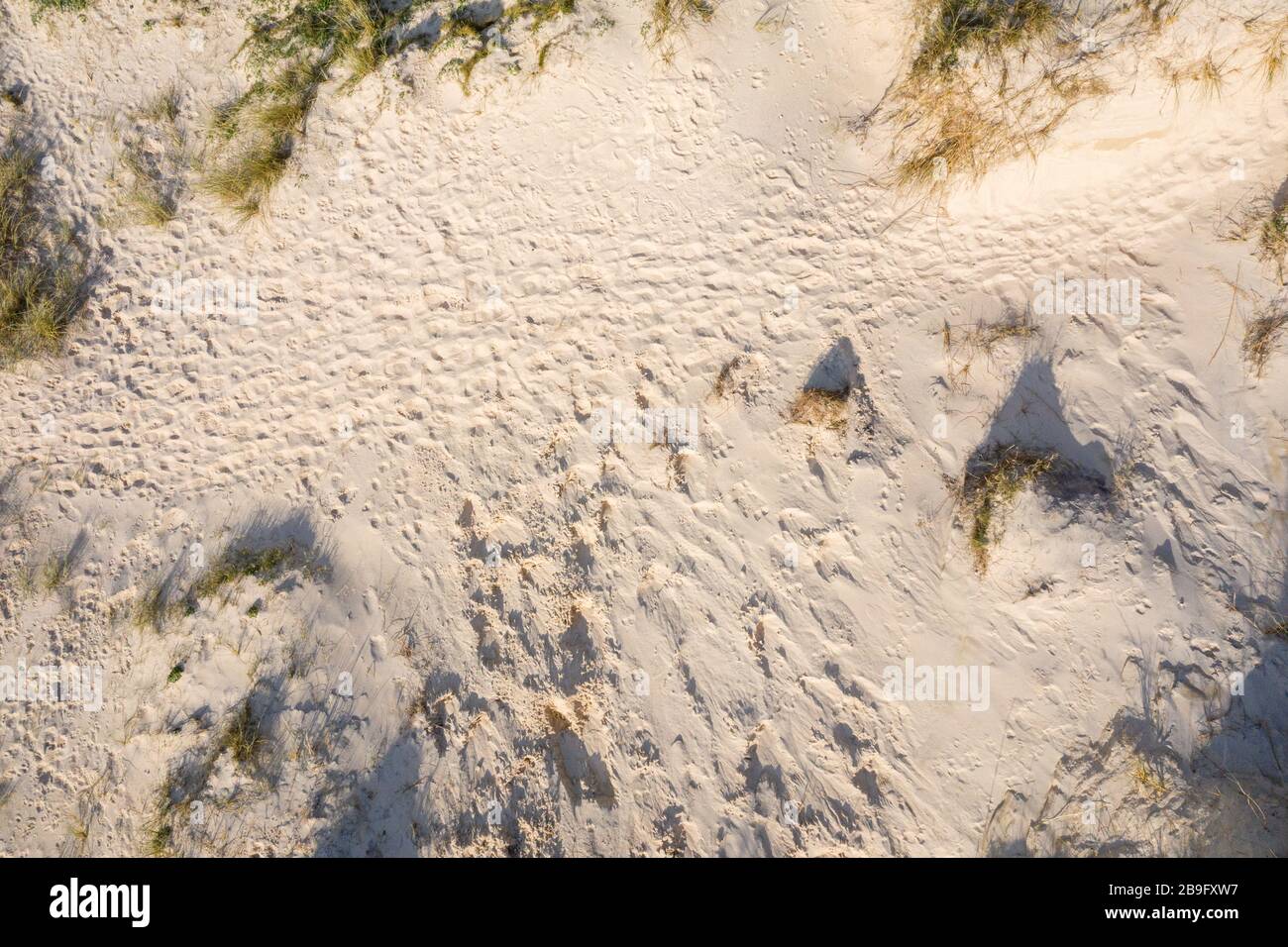 aerial image of footprints in the sand on a sand dune Stock Photo