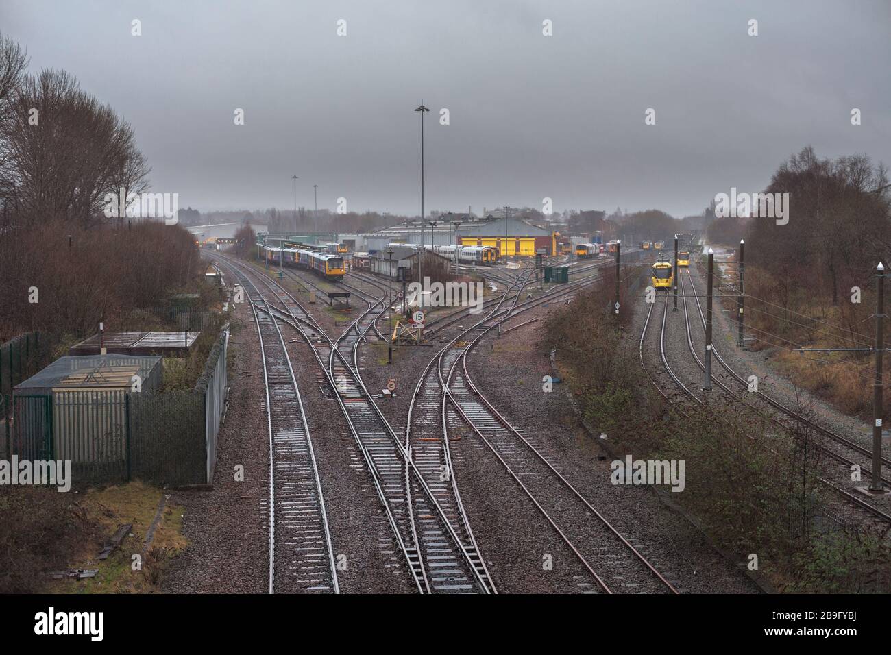 Northern Rail train maintenance depot at Newton Heath, Manchester with passing metrolink trams. Stock Photo