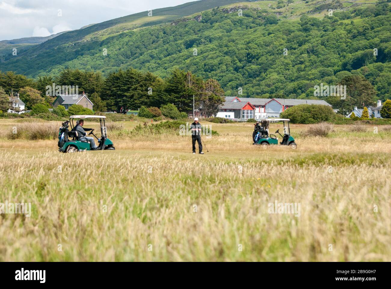 Playing golf near Harlech Castle in Wales Stock Photo