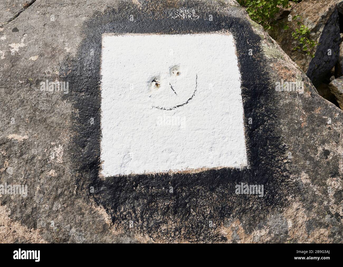 Smiley face in white concrete Stock Photo
