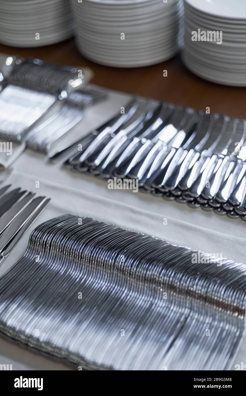 Caterers silverware organized in rows Stock Photo