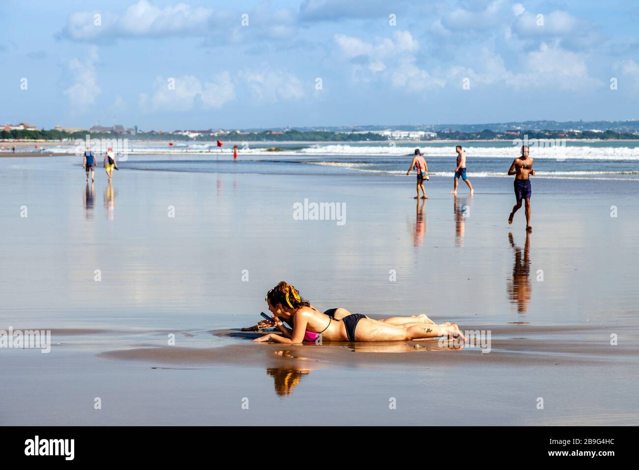Two Female Tourists Relaxing On Seminyak Beach, Bali, Indonesia. Stock Photo