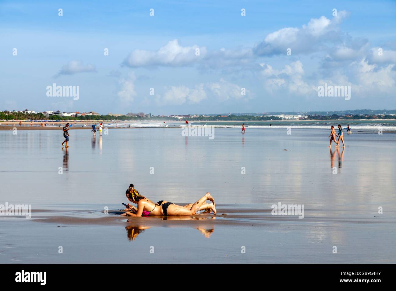Two Female Tourists Relaxing On Seminyak Beach, Bali, Indonesia. Stock Photo