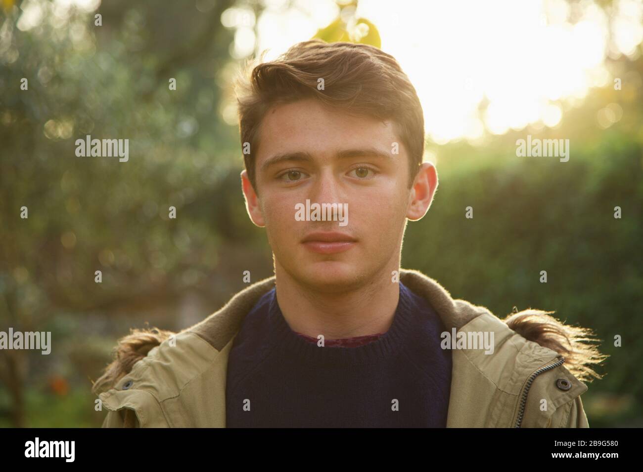 Portrait confident teenage boy in park Stock Photo