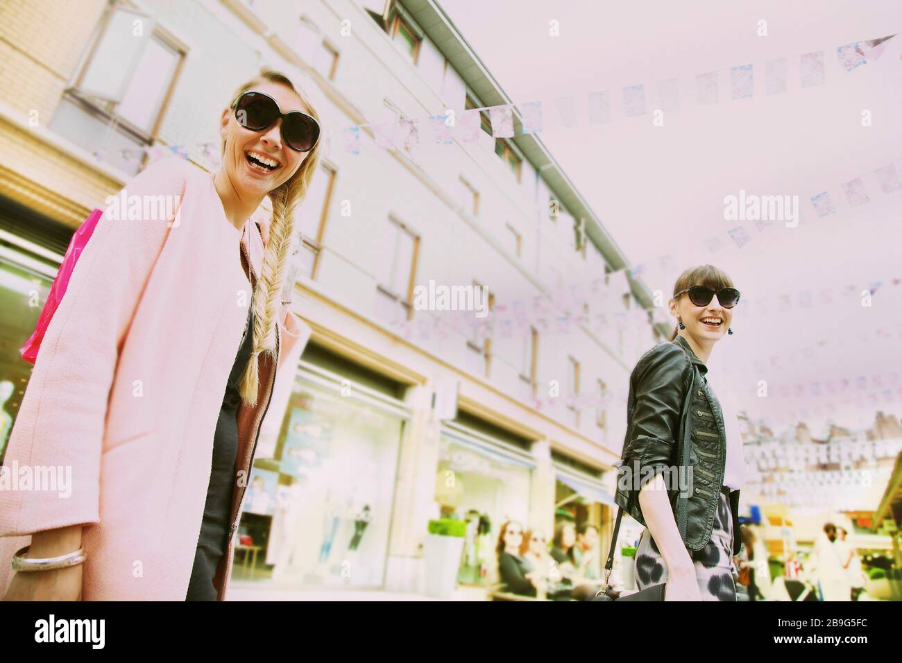 Portrait happy young women in sunglasses on urban street Stock Photo