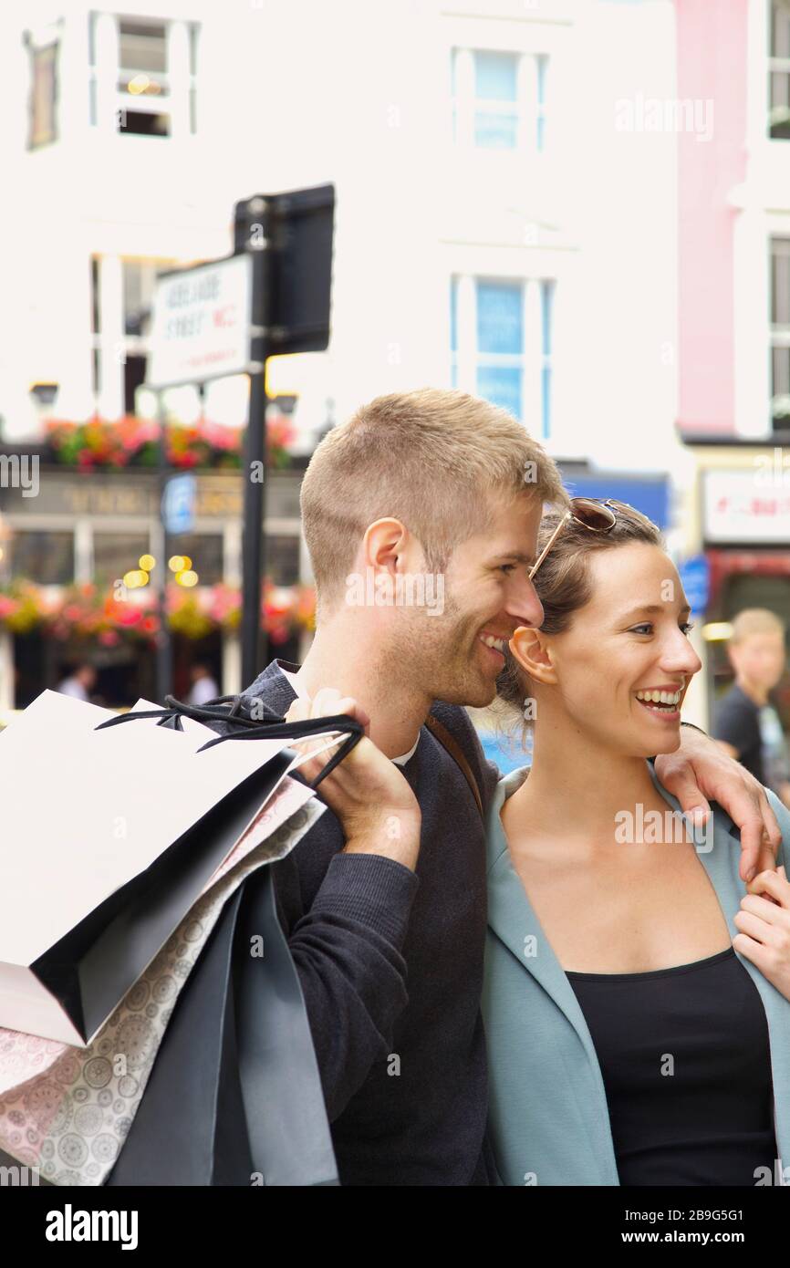 Happy couple shopping in city Stock Photo
