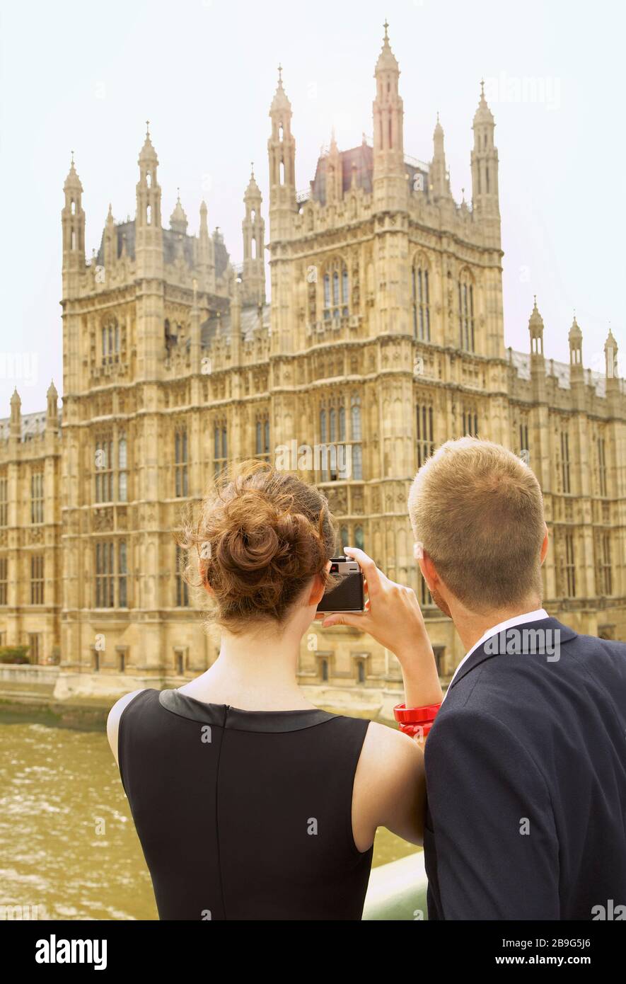 Young couple with camera photographing Houses of Parliament, London, UK Stock Photo