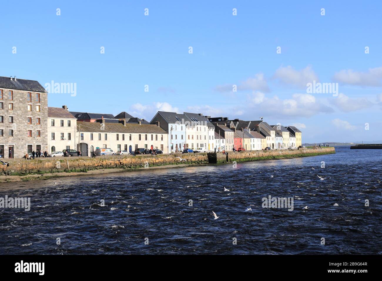 view of the Long Walk, Galway city in the distance,  blue river water in the foreground Stock Photo