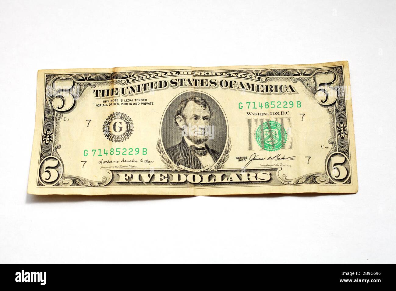 old five dollar bill on a white background isolate Stock Photo