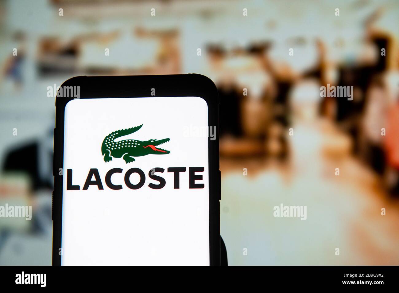 In this photo illustration a Lacoste logo seen displayed on a smartphone. Stock Photo