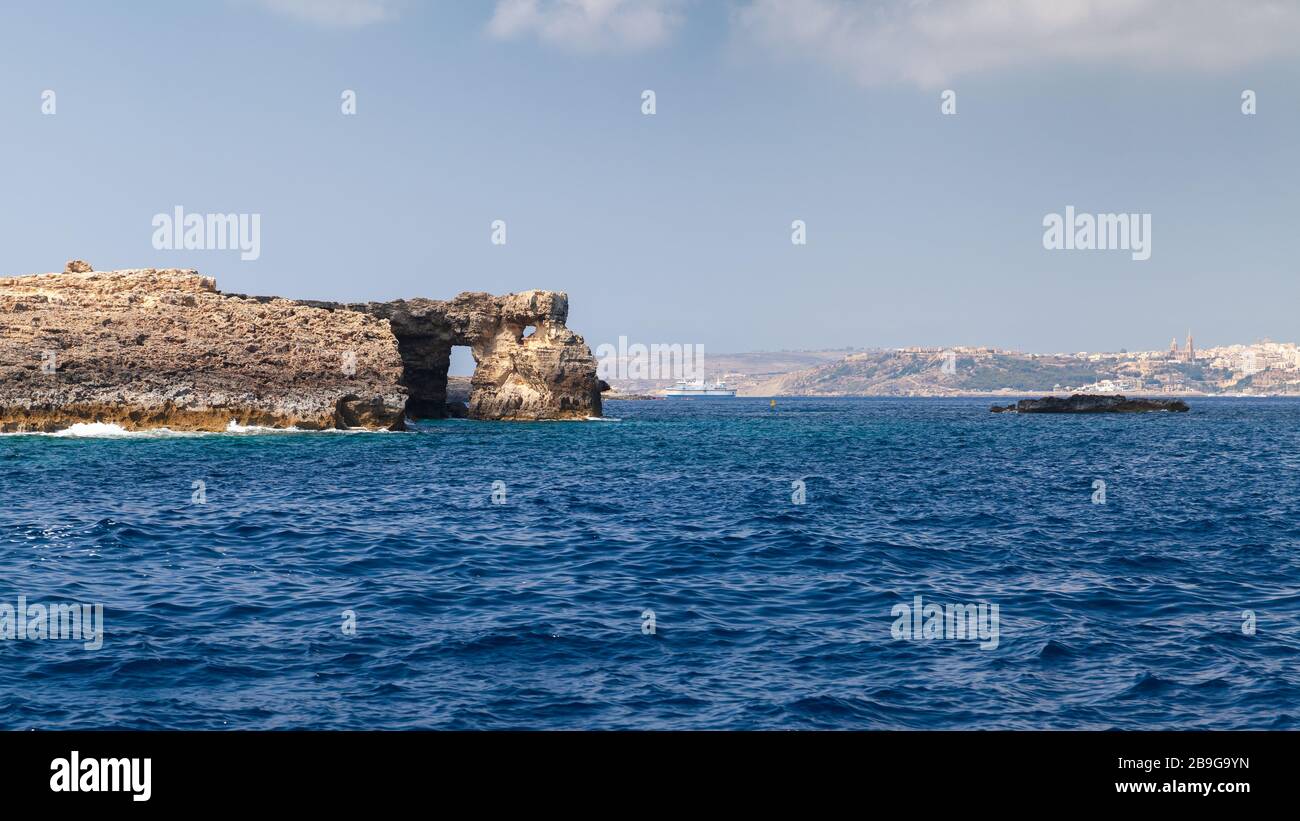 Summer landscape with natural stone arch on a coast of Comino island, Malta Stock Photo