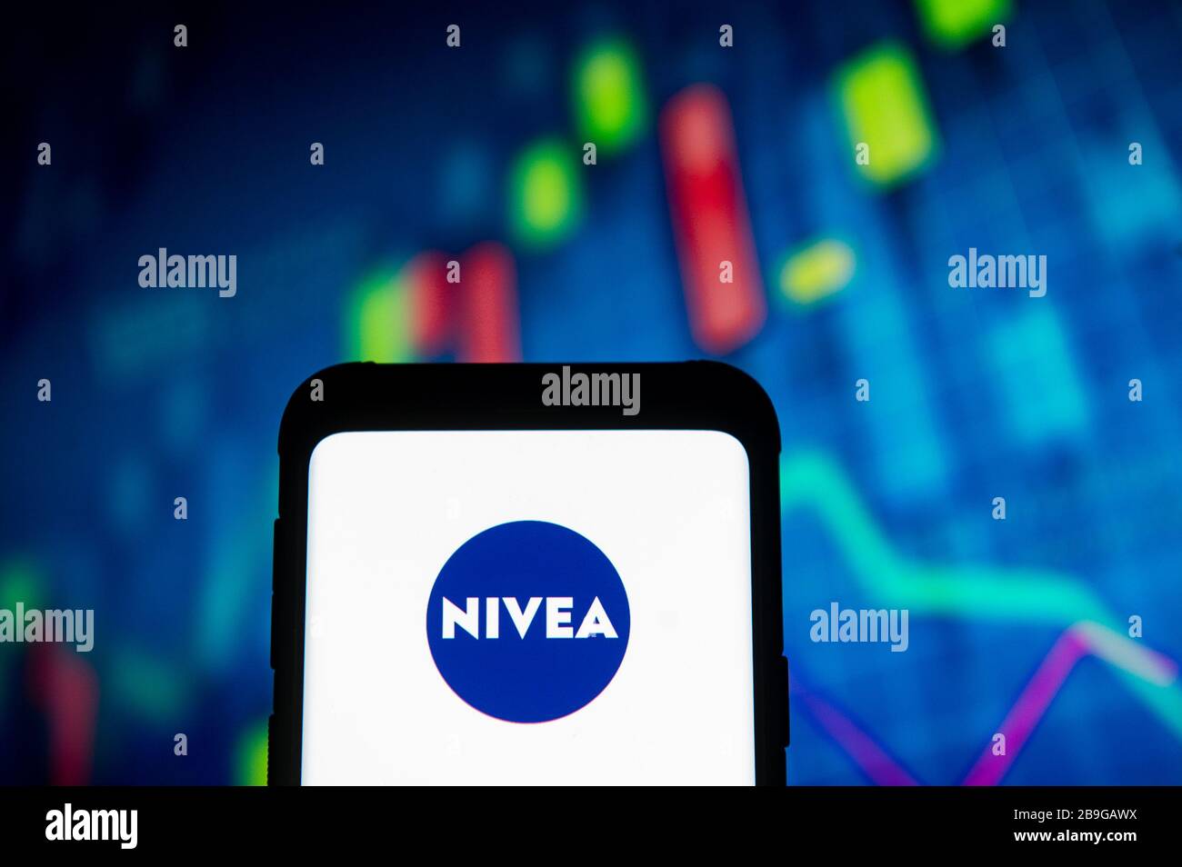 In This Photo Illustration A Nivea Logo Seen Displayed On A Smartphone A Stock Market Chart Is Being Displayed As The Background Stock Photo Alamy